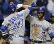  ?? CHRIS O’MEARA/THE ASSOCIATED PRESS ?? Blue Jays third baseman Josh Donaldson is congratula­ted by Jose Bautista after hitting one of Toronto’s three home runs.