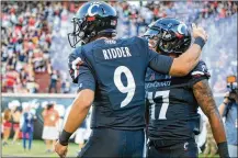  ?? JUSTIN CASTERLINE / GETTY IMAGES ?? Quarterbac­k Desmond Ridder and wide receiver Rashad Medaris celebrate after a touchdown during Cincinnati’s rout of Alabama A&amp;M on Saturday.