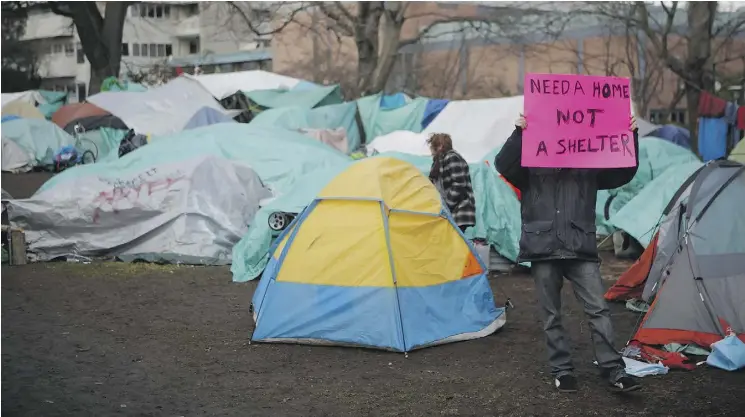  ?? CHAD HIPOLITO / THE CANADIAN PRESS ?? Residents of the homeless camp in Victoria are vowing to stay despite the B.C. government’s offer of alternate shelter. Tents began appearing here in June; there are now about 100 homeless people living on the courthouse grounds, with more arriving all...