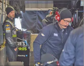  ?? Associated Press ?? Tough stretch: Jimmie Johnson watches his crew in the garage during practice for the NASCAR Cup Series auto race at Martinsvil­le Speedway in Martinsvil­le, Va., Saturday.