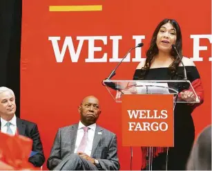  ?? Photos by Mark Mulligan / Staff photograph­er ?? Small-business owner Diana Rosas, with Wells Fargo CEO Charlie Scharf, left, and Mayor Sylvester Turner, announces a donation to the Fund for Social Justice and Economic Equity.