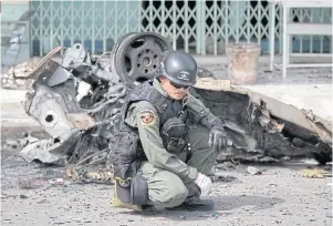  ??  ?? A police expert inspects the site of a car bomb attack in Narathiwat in February 2015. Separatist violence in the three southern border provinces of Thailand has claimed some 7,000 lives, mostly civilians, since 2004.