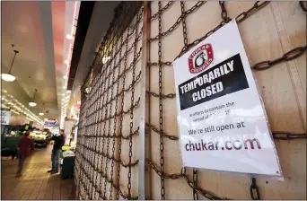  ?? ELAINE THOMPSON — THE ASSOCIATED PRESS ?? By Christophe­r Rugaber The Associated Press
Business closures across the country, like this shop in the Pike Place Market in Seattle, has caused record number of people to seek unemployme­nt benefits, the U.S. Labor Department reported Thursday.