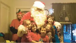  ?? COURTESY PHOTO ?? Brian Credle plays Santa Claus during the 2016 holiday season with a group of children in Portsmouth. .