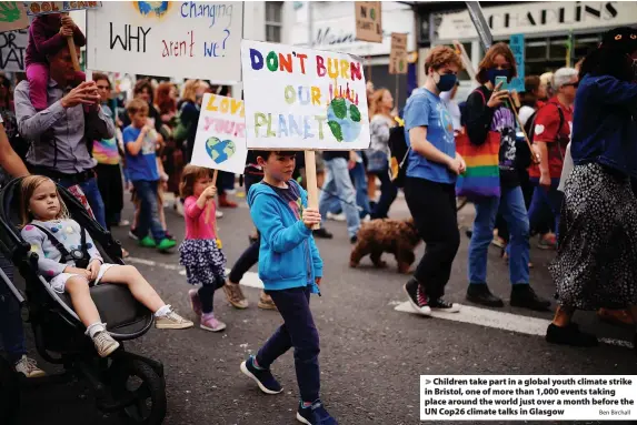  ?? Ben Birchall ?? > Children take part in a global youth climate strike in Bristol, one of more than 1,000 events taking place around the world just over a month before the UN Cop26 climate talks in Glasgow