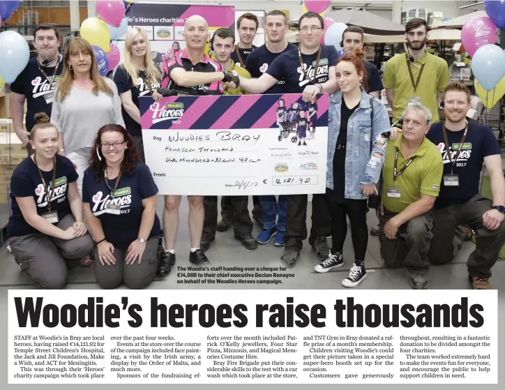  ??  ?? The Woodie’s staff handing over a cheque for €14,000 to their chief executive Declan Ronayne on behalf of the Woodies Heroes campaign.