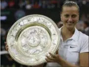  ?? SANG TAN — THE ASSOCIATED PRESS FILE ?? In this July 5, 2014 photo, Petra Kvitova, of Czech Republic, holds the trophy after winning the women’s singles final against Eugenie Bouchard at the All England Lawn Tennis Championsh­ips in Wimbledon, London.