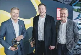  ?? Jorg Carstensen AFP via Getty Images ?? BMW CEO Oliver Zipse, left, Tesla and SpaceX CEO Elon Musk and Volkswagen CEO Herbert Diess after a Golden Steering Wheel ceremony Tuesday in Berlin.