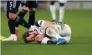  ??  ?? Harry Kane clutches his knee during Spurs’s 2-0 victory over Dinamo Zagreb on Thursday. The striker was later seen with an ice-pack over the joint, raising fears he will miss Sunday’s north London derby. Photograph: Andrew Fosker/BPI/Shuttersto­ck