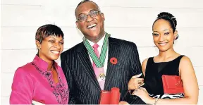  ?? FILE ?? Gleaner columnist Ian Boyne enjoys the company of his wife, Margaret (left), and daughter, Kelly Ann, after he was presented with the Order of Distinctio­n, Commander Class, for his contributi­on to the field of journalism in 2009.