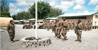  ?? Picture: EPA-EFE ?? SCENE OF ATTACK. US Air Force airmen from the 475th Expedition­ary Air Base Squadron conducting a flag-raising ceremony at Camp Simba in Lamu, Kenya, in August.