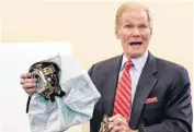  ?? [AP FILE PHOTO] ?? Senate Commerce Committee member Sen. Bill Nelson, D-Fla., holds an example of the defective airbag made by Takata of Japan that has been linked to multiple deaths and injuries in cars driven in the U.S., on Nov. 20 during the committee’s hearing on...