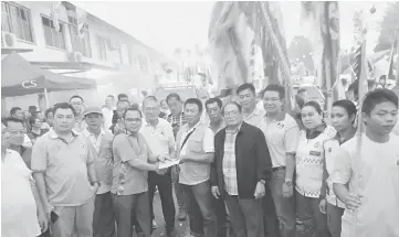  ??  ?? Nyalau (front, fifth right) with members of the local community during the Chinese New Year procession at Lubok Antu town.