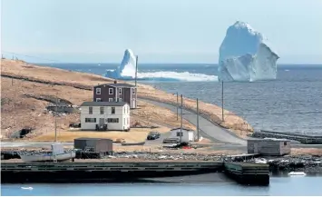  ?? PAUL DALY/CP FILES ?? A large iceberg is visible from the shore in Ferryland, an hour south of St. John’s, earlier this month.