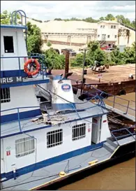  ?? Special to the Arkansas Democrat- Gazette ?? The towboat Chris M, owned by Jeffrey Sand Co. in North Little Rock, was damaged Sunday morning when a natural gas pipeline in the Arkansas River ruptured.