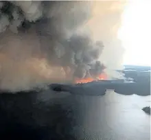  ?? JUDY KLASSEN/ HANDOUT ?? Manitoba MLA Judy Klassen provided this image showing a large forest fire seen burning near Wasagamack First Nation in northern Manitoba on Tuesday. The Red Cross is working to carry out the evacuation of three northern Manitoba communitie­s threatened...