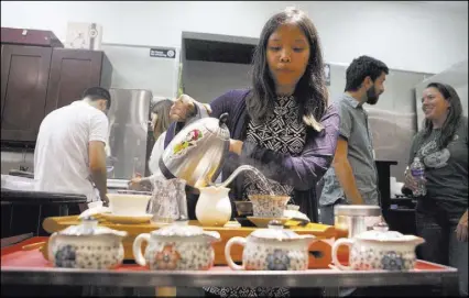  ??  ?? Rie Tulali prepares the tea at a tasting event at Niu-Gu restaurant. Some of the teas were rare finds.