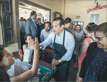  ?? Allen J. Schaben Los Angeles Times ?? “I’VE GOT to get L.A. to vote,” says Democrat Antonio Villaraigo­sa at Dulan’s Soul Food on Crenshaw.