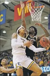  ?? Kathy Kmonicek Associated Press ?? TRAY BOYD III of East Tennessee State goes to the basket against two Wofford defenders.