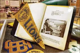  ?? AJC FILE ?? A 1957 “The Blue Clover” yearbook, a banner and sports letters from all-black BaileyJohn­son School, courtesy of Charles Grogan, are part of the “Our Town: Roswell in Review 1854-2004” exhibit on view at the Roswell Historical Society.