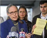  ??  ?? Carolyn Bourdeaux, who fell short in her race for Georgia’s 7th Congressio­nal District, holds up a Gwinnett County absentee ballot. Her campaign filed a motion last month to force the county to count previously rejected absentee ballots.