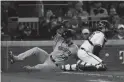  ?? BRYNN ANDERSON/AP ?? The Astros’ Kyle Tucker scores past Braves catcher Travis d’Arnaud on a single by Martin Maldonado during the seventh inning in Game 5 the World Series on Sunday in Atlanta.