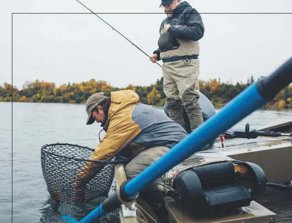  ??  ?? Kraft helps Collier unhook a sockeye salmon during a day of fishing on the Kvichak River, a waterway downstream from the proposed Pebble Mine.