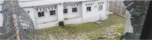  ??  ?? RIAU PROVINCE: Prison buildings are seen through a broken window at Sialang Bungkuk Prison in Pekanbaru, Riau province, Indonesia yesterday. — AP