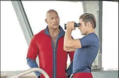  ?? CONTRIBUTE­D BY FRANK MASI/PARAMOUNT PICTURES ?? Dwayne Johnson and Zac Efron star in “Baywatch.”