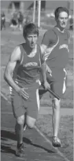  ?? RANDY MOLL NWA NEWSPAPERS ?? Chris Sims, a Farmington senior, takes the baton from Mitchell Hipps to begin the final leg of the boys 4 x 800 meter relay. Farmington recorded a time of 9:21 placing third at the Pioneer Relays meet held at Gentry on April 11. Tyrac Polingo and Corey...