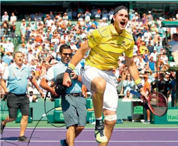  ?? — AFP ?? John Isner of the United States celebrates after his victory against Alexander Zverev of Germany in the men’s final during the Miami Open at the Crandon Park Tennis Center on Sunday in Key Biscayne, Florida. Isner won 6-7 (4/7), 6-4, 6-4.