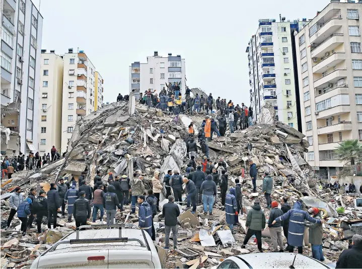  ?? ?? Rescue workers search for survivors in Adana, main. Shellshock­ed residents survey the damage in Kahramanma­ras near the epicentre of the first earthquake, below