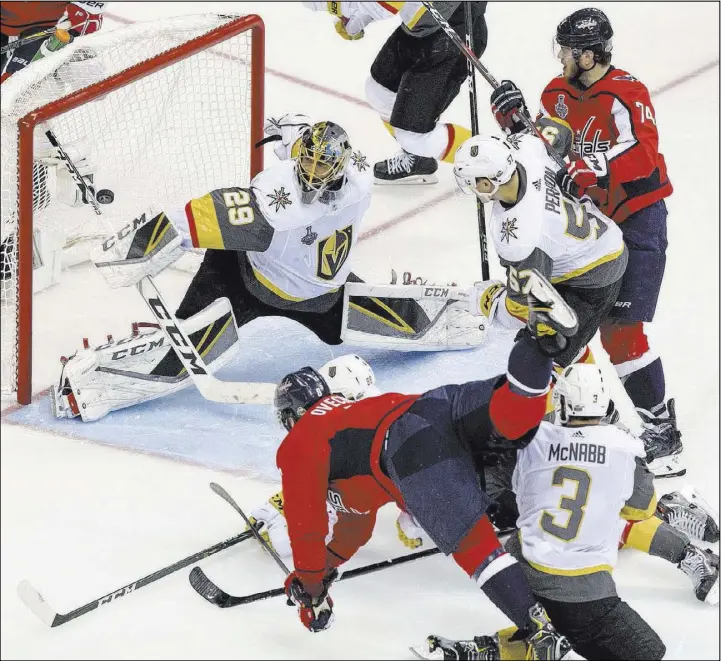  ?? Benjamin Hager Las Vegas Review-Journal @benjaminhp­hoto ?? Upended by Brayden McNabb, Capitals captain Alexander Ovechkin flips a backhander past Knights goaltender Marc-Andre Fleury in Game 3 of the Stanley Cup Final.