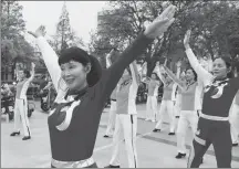  ?? JIANG XIAOWEI / FOR CHINA DAILY ?? Residents dance to music received through earphones instead of a loud speaker in Shanghai’s Jiading district this month.