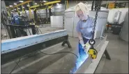  ?? (Telegraph Herald/Jessica Reilly) ?? Vic Bode tack welds a stainless steel beam at Unison Solutions in Dubuque, Iowa. Bode, a senior at Dubuque High School, is in a welding apprentice­ship offered through Dubuque Community Schools. “I love coming here in the morning. … I love this environmen­t,” she said.