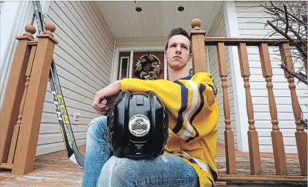  ?? PAUL DALY THE CANADIAN PRESS ?? Mason Oates, co-captain of the Astros, the Ascension Collegiate hockey team, poses at his home in Bay Roberts, N.L. on Thursday.