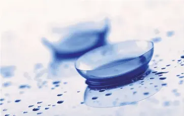  ?? COURTESY OF EVERYDAY CONTACTS ?? Albuquerqu­e contact lens startup EveryDay Contacts provided this image of contacts amid liquid to emphasize the unique aspect of its new product, which has a coating that actually attracts moisture for additional comfort.
