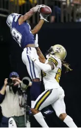  ?? Jonathan Bachman, Getty Images ?? Cowboys receiver Michael Gallup catches a touchdown as the Saints’ Bradley Roby defends in the first quarter Thursday in New Orleans.