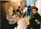  ?? ?? Congregati­on members fill the hallway behind the pulpit Saturday as they are walked through how to escape during active shooter training.