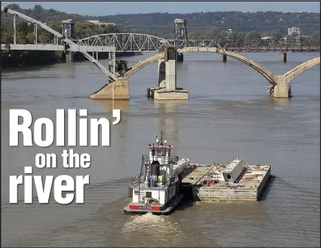  ?? Arkansas Democrat-Gazette archive photo ?? A tow boat moves a barge on the Arkansas River, part of the McClellan-Kerr Navigation System.