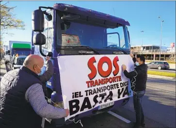  ?? Paul White Associated Press ?? DOZENS of truckers rolled through Madrid last week in a “slow march” protest against skyrocketi­ng fuel prices. Many feel that they helped keep Spain going during the shutdown but are now being left behind.
