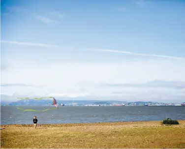  ?? PHOTOS BY SARAH RICE / SPECIAL TO THE CHRONICLE ?? A child runs at Crown Memorial State Beach, a restored marshland in Alameda. From 1917 to 1939 on the same stretch of land was Neptune Beach amusement park that featured concerts and carnival rides.