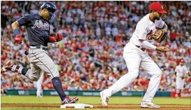  ?? JEFF ROBERSON / AP ?? Braves rookie Ronald Acuna, who went 0 for 4 in his return from the DL, is forced out as Cardinals first baseman Jose Martinez handles the throw Friday.