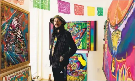  ?? KRISTIAN CARREON FOR THE U-T ?? Artist German Corrales, 38, who has contribute­d to murals in Chicano Park, moved into a unit at Monarch Studios last year.