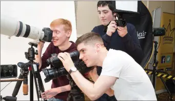  ??  ?? Students Samuel Muller, Padraig Foran and Niall O’Brien getting some tips on photograph­y at the Kerry ETB fair in The Brandon Hotel Conference Centre on Thursday
