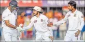  ?? AFP ?? Bangladesh players congratula­te Mayank Agarwal after his double ton during the first Test in Indore.