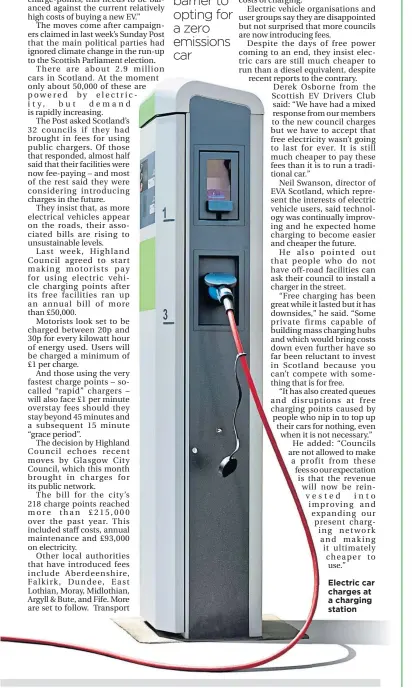  ??  ?? Electric car charges at a charging station