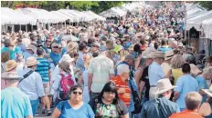  ?? EDDIE MOORE/JOURNAL ?? Thousands of people wander by the booths on Lincoln Avenue during the 96th annual Santa Fe Indian Market held last year.