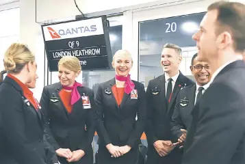  ??  ?? Cabin crew wait to board a Qantas 787 Dreamliner before taking off on its inaugural flight from Perth to London on March 24. Qantas’ 14,498 kilometre (9,009-mile) journey from the southweste­rn city to London is the world’s third-longest passenger...