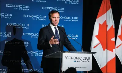  ?? CP PHOTO ?? Finance Minister Bill Morneau addresses an Economic Club of Canada breakfast in Calgary on Wednesday. Morneau pledged to get constructi­on started on the Trans Mountain pipeline expansion “this constructi­on season.”